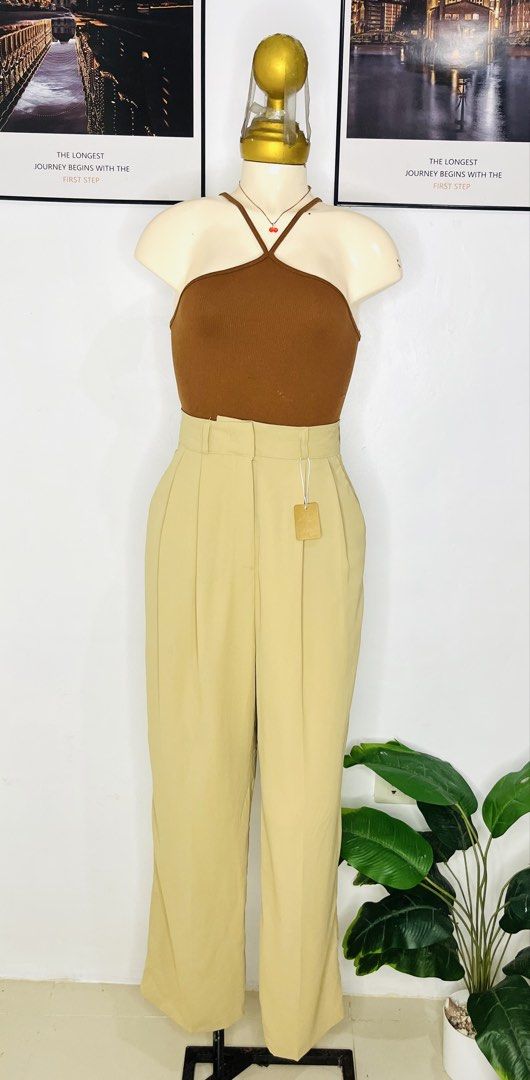 Beige Trousers Pants | Size 24-25 (Category: Trousers) located in Manila. Submitted by bengirlclothing (Listing ID 1469485870, Image 2). Description: - Color: Classic Beige - Fit: High-waist with straight leg - Details: Front pleats, belt loops, and two back pockets with welt detailing - Condition: Brand new with tag attached - Style: Clean, structured, and versatile for work or casual wear.