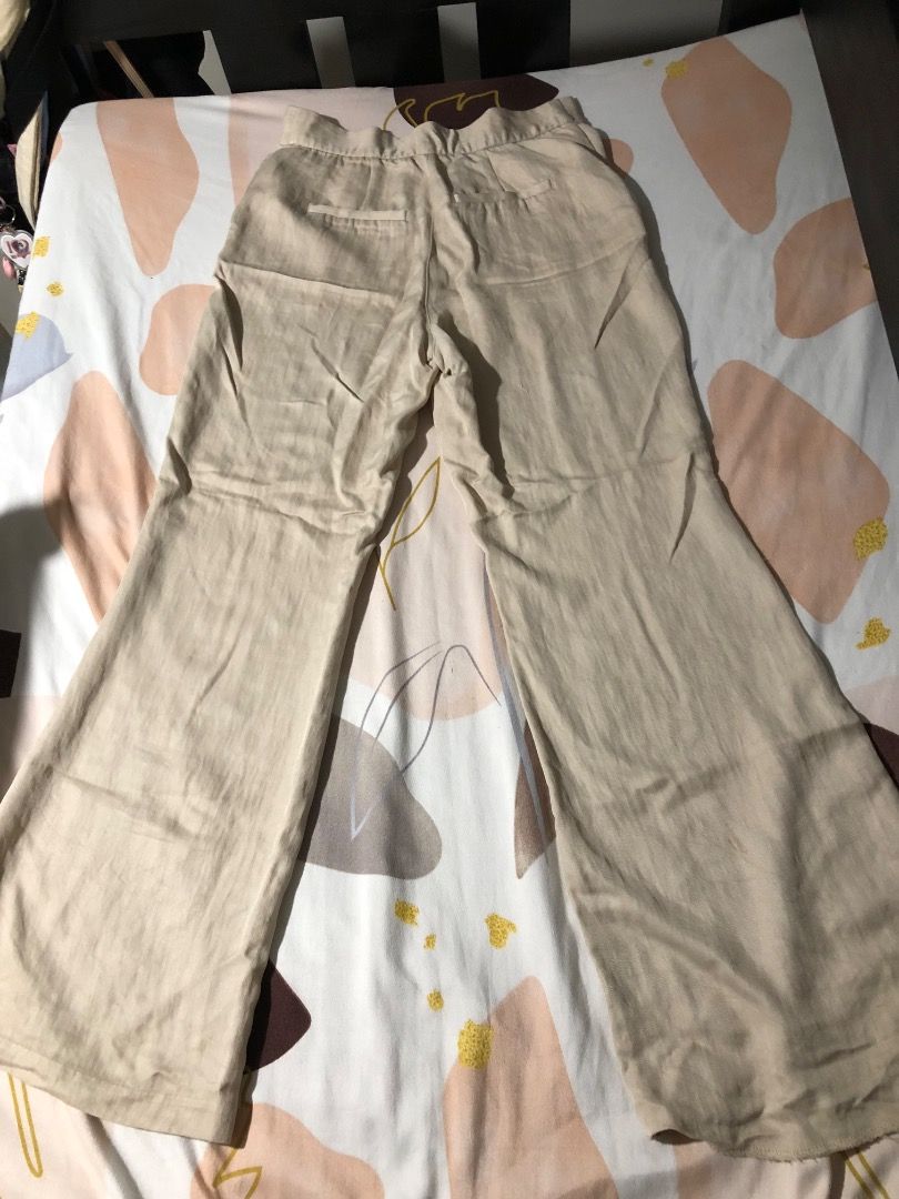 Beige Wide Leg Trousers (Category: Jeans) located in Manila. Submitted by luckytiger_0a94ff (Listing ID 1469484156, Image 2). Description: - Color: Versatile beige - Fit: High-waist with a relaxed, wide-leg cut - Details: Features functional back pockets - Fabric: Lightweight and textured for all-day comfort - Styling: Perfect for pairing with basic tees or elegant blouses.