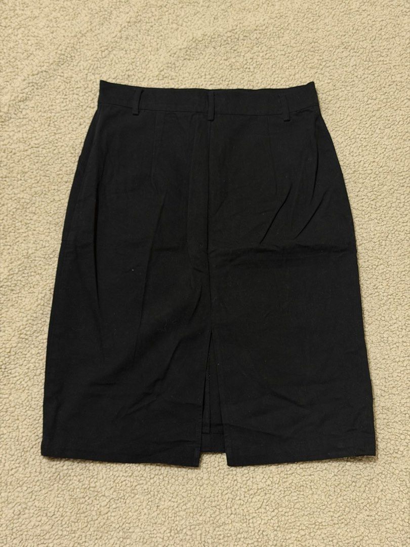 Bench Black Midi Skirt Size Medium (Category: Skirts) located in Las Pinas. Submitted by ann.co. (Listing ID 1469544548, Image 2). Description: - Brand: Bench - Size: Medium - Color: Classic Black - Style: Straight cut midi skirt - Details: Front button closure, belt loops, two deep front pockets, and a back slit hem - Condition: Great staple piece - Versatility: Perfect for both casual outings and office wear.