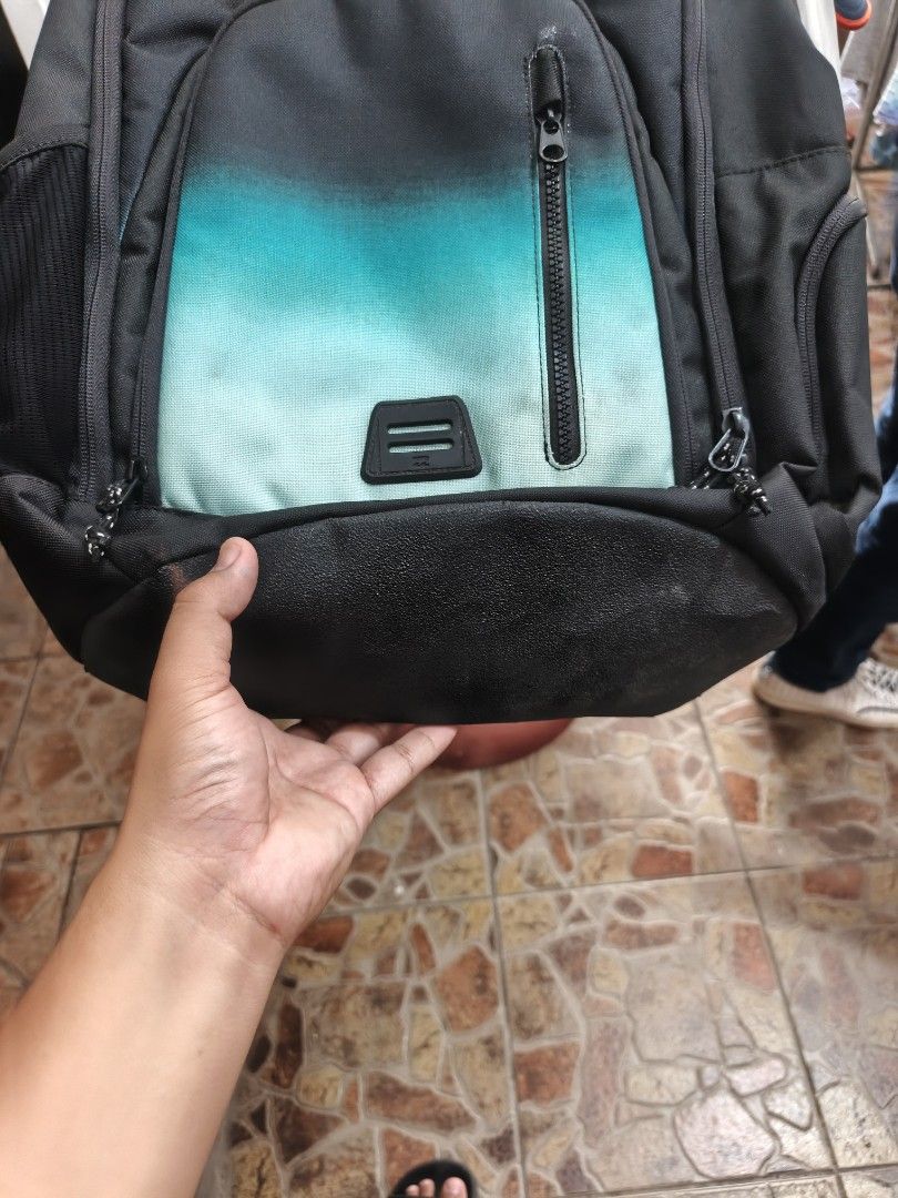 Billabong Black Yellow Teal Gradient Backpack (Category: Backpacks) located in Bayombong. Submitted by onlygoodfinds. (Listing ID 1469409616, Image 3). Description: - Brand: Billabong - Colorway: Black, yellow, and teal gradient - Comfort: Mesh back padding and adjustable shoulder straps with branded tag - Storage: Spacious main compartment for books/gear plus front zipped compartment with branded patch and pulls - Condition: Durable fabric that 