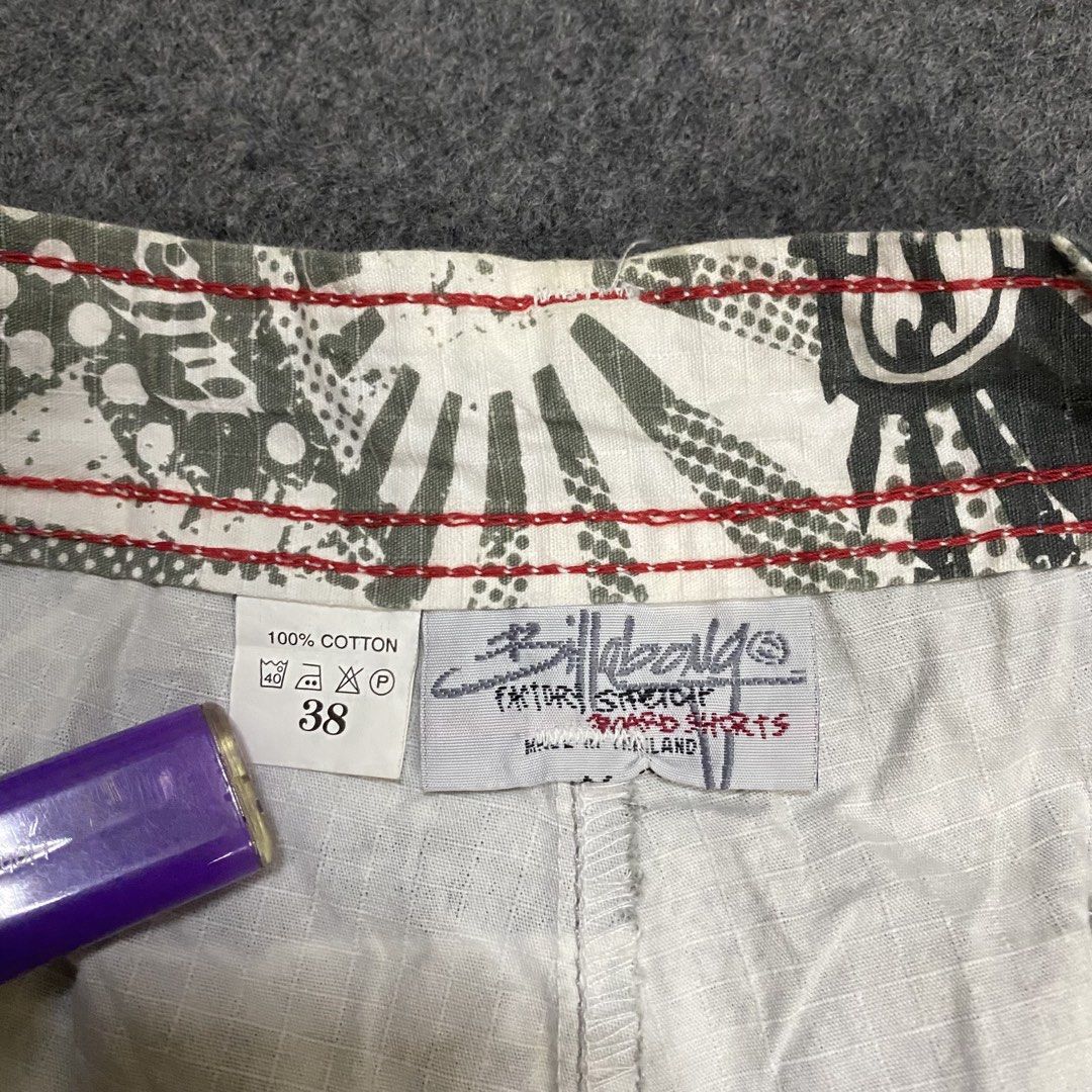 Billabong Board Shorts Cargo 38 (Category: Swim Trunks & Board Shorts) located in Cebu City. Submitted by callmejasonx (Listing ID 1469416593, Image 3). Description: - Brand: Billabong - Style: Cargo board shorts in grey and white graphic camo pattern - Size: Tagged Size 38 - Material: 100% cotton factory stretch fabric for comfort - Features: Multiple cargo pockets on legs and back, embroidered logos, and red contrast stitching along the inner w