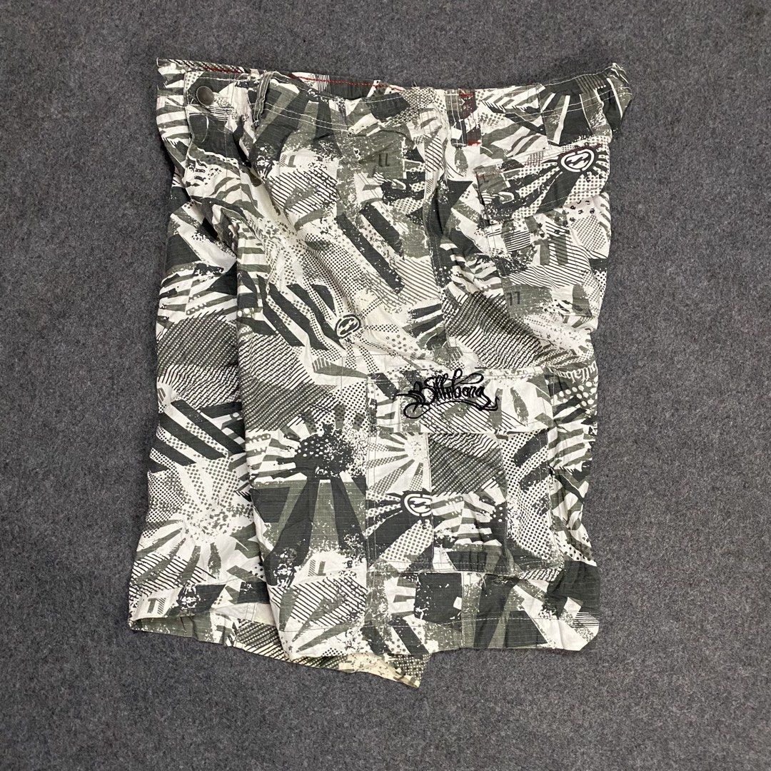 Billabong Board Shorts Cargo 38 (Category: Swim Trunks & Board Shorts) located in Cebu City. Submitted by callmejasonx (Listing ID 1469416593, Image 2). Description: - Brand: Billabong - Style: Cargo board shorts in grey and white graphic camo pattern - Size: Tagged Size 38 - Material: 100% cotton factory stretch fabric for comfort - Features: Multiple cargo pockets on legs and back, embroidered logos, and red contrast stitching along the inner w