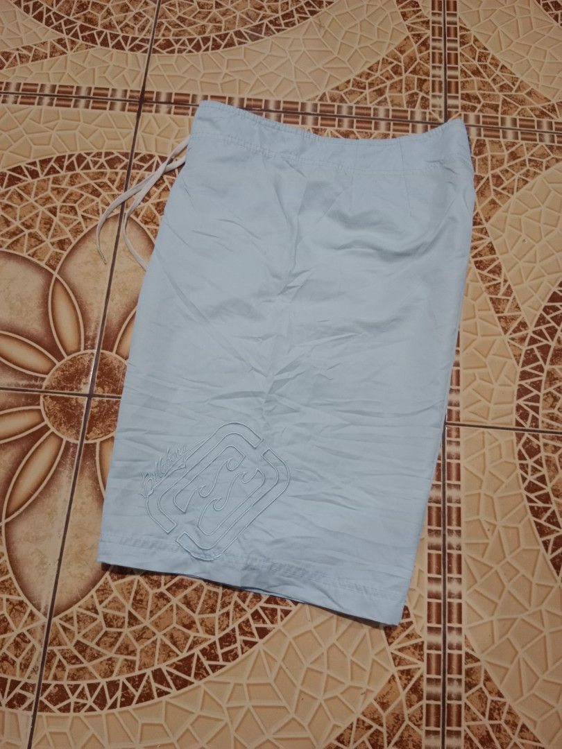 Billabong Light Blue Board Shorts Size 34 (Category: Swim Trunks & Board Shorts) located in Toledo. Submitted by zealzionta54269 (Listing ID 1469410003, Image 1). Description: - Brand: Billabong - Color: Light blue - Size: 34 - Material: 100% polyester - Waist: Drawstring closure - Pockets: Side cargo pocket with grommets and flap closure - Branding: Embroidered logos on front and back - Ideal for: Beach, pool, and casual surf wear.
