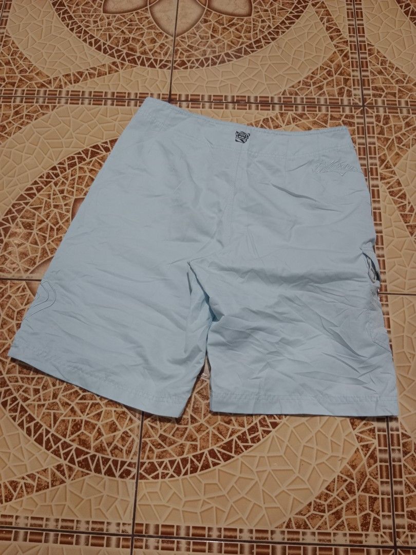 Billabong Light Blue Board Shorts Size 34 (Category: Swim Trunks & Board Shorts) located in Toledo. Submitted by zealzionta54269 (Listing ID 1469410003, Image 2). Description: - Brand: Billabong - Color: Light blue - Size: 34 - Material: 100% polyester - Waist: Drawstring closure - Pockets: Side cargo pocket with grommets and flap closure - Branding: Embroidered logos on front and back - Ideal for: Beach, pool, and casual surf wear.