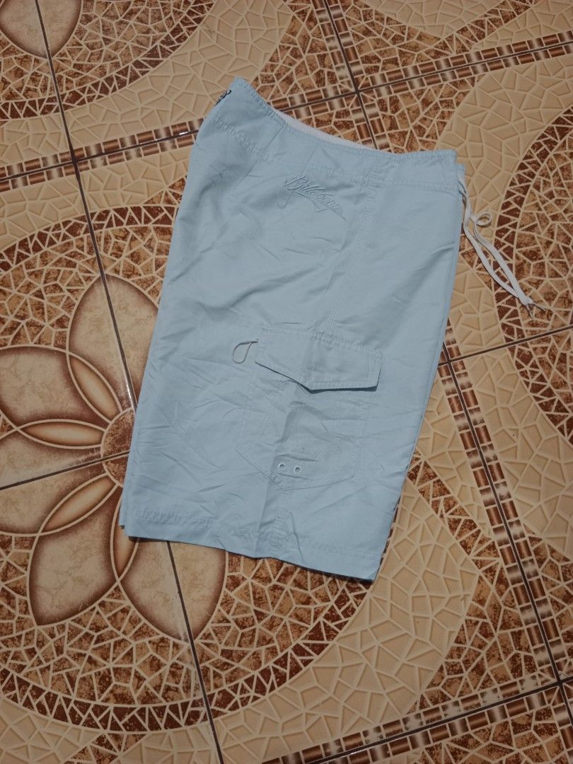 Billabong Light Blue Board Shorts Size 34 (Category: Swim Trunks & Board Shorts) located in Toledo. Submitted by zealzionta54269 (Listing ID 1469410003, Image 3). Description: - Brand: Billabong - Color: Light blue - Size: 34 - Material: 100% polyester - Waist: Drawstring closure - Pockets: Side cargo pocket with grommets and flap closure - Branding: Embroidered logos on front and back - Ideal for: Beach, pool, and casual surf wear.