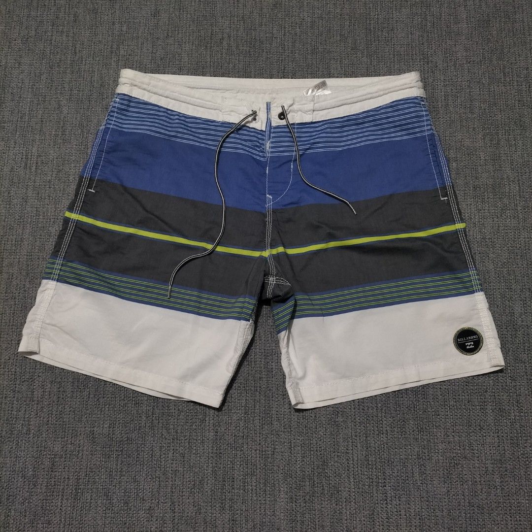 Billabong Striped Board Shorts Size 36 (Category: Swim Trunks & Board Shorts) located in Taytay. Submitted by calmtree-6248 (Listing ID 1469536619, Image 1). Description: - Brand: Billabong - Size: 36 - Design: Horizontal stripe pattern in blue, grey, white, and lime green - Features: Drawstring closure, metal grommets with logo stamp, and right-side back zippered pocket - Material: 53% cotton, 47% polyester blend.