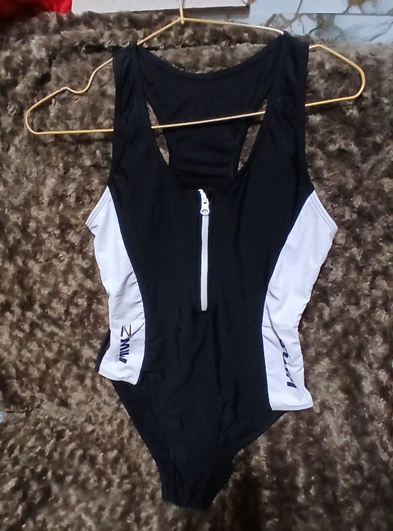 Black and White Front Zip Swimsuit with Racerback (Category: Bikinis & Swimsuits) located in Taguig. Submitted by jegadablo (Listing ID 1469498780, Image 2). Description: - Color: Classic black with contrasting white side panels - Design: Front center zipper with white pull tab and racerback cut for great shoulder mobility - Fit: Stretchy material that hugs the body nicely - Style: Simple, sporty, and functional for swimming or water sports - Con