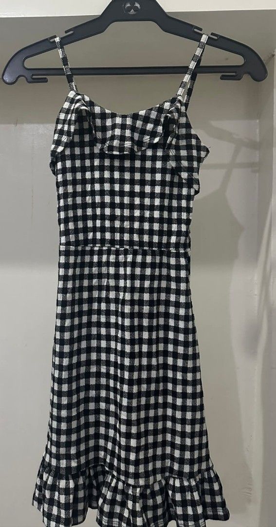 Black and white gingham spaghetti strap ruffle dress (Category: Dresses) located in Manila. Submitted by livewater-0f48 (Listing ID 1469517903, Image 1). Description: - Style: Black and white checkered midi dress - Design: Thin spaghetti straps, sleeveless with a fitted waist - Details: Ruffled neckline and matching ruffle hem - Perfect for: Picnics, dates, or casual days out - Condition: Brand new / Excellent.