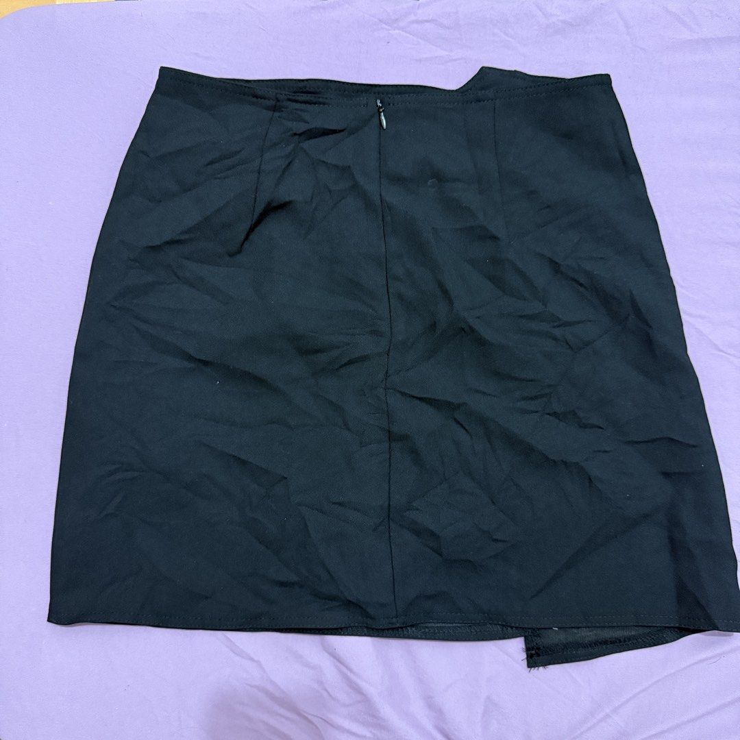 Black Asymmetric Hem Mini Skirt (Category: Skirts) located in Legazpi City. Submitted by maerixx (Listing ID 1469508404, Image 2). Description: Size 26 - Color: Black - Style: Mini skirt with asymmetrical wrapped front - Closure: Concealed back zip - Fit: Sits around mid-thigh, smooth fabric with minimal stretch - Condition: Excellent, no stains or loose threads - Pairing: Easy to match with crop tops and basic tees.