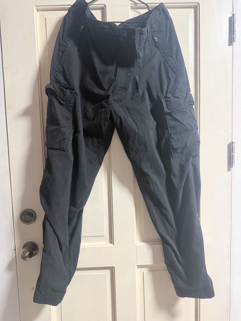 Black Cargo Pants with Multiple Pockets and Drawstring (Category: Joggers) located in Tagum. Submitted by hachiiing (Listing ID 1469393945, Image 2). Description: - Color: Deep black with no fading - Fit: Relaxed fit with built-in drawstring waist and button closure - Features: Multiple utility pockets on the sides for ample storage - Condition: Great for daily wear and highly versatile style WAIST 38-40 LENGTH 42.