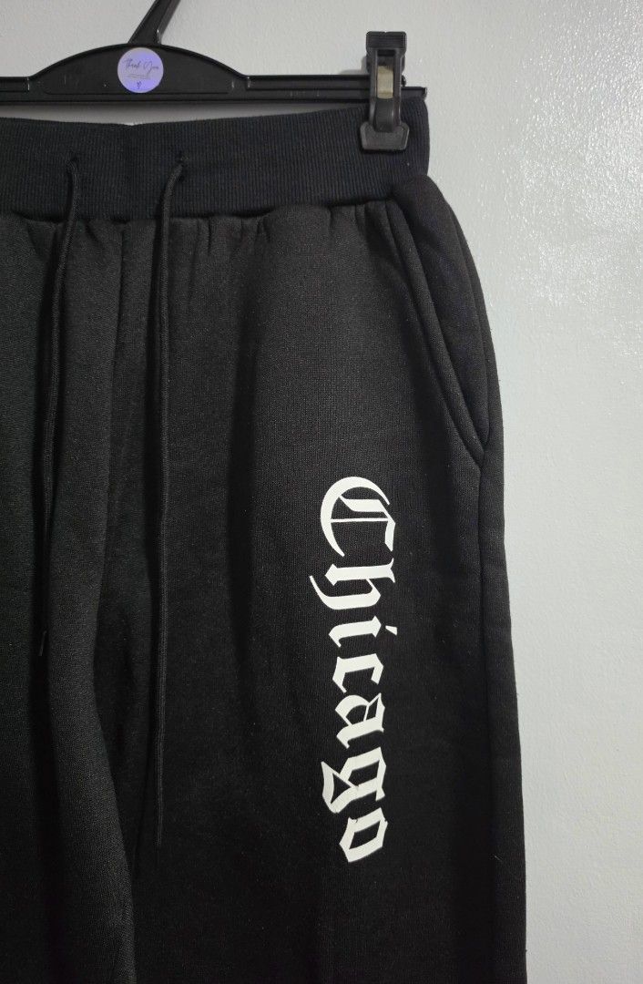 Black Chicago Graphic Sweatpants Joggers (Category: Jeans) located in Paranaque City. Submitted by franinnashop (Listing ID 1469459101, Image 2). Description: Declutter - Style: Casual streetwear black sweatpants with white Chicago gothic text on the left leg - Comfort: Soft fleece fabric inside, perfect for everyday wear - Features: Thick elastic waistband with adjustable drawstring cords and deep side pockets - Measurements: Waist 24 to 34 inch