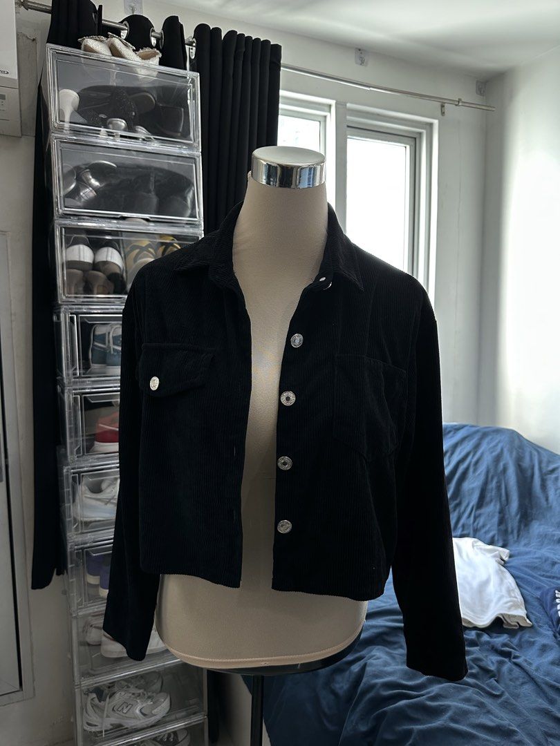 Black Corduroy Cropped Button-Up Jacket (Category: Coats, Jackets and Outerwear) located in Quezon City. Submitted by valeriorac74670 (Listing ID 1469455956, Image 2). Description: - Color: Black - Material: Textured corduroy fabric - Fit: Cropped fit with long sleeves - Closure: Classic button-down front with shiny silver buttons - Collar: Standard collar - Pockets: Two chest pockets (left side features a flap pocket with a matching silver butto
