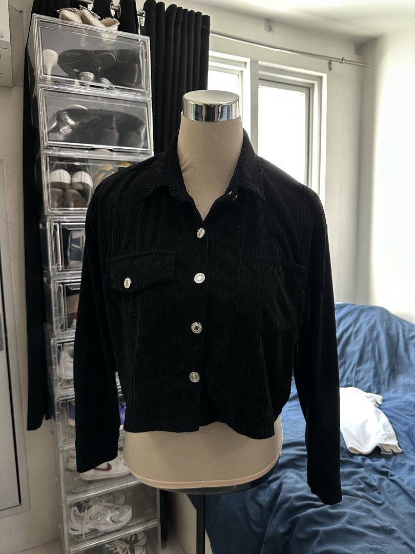 Black Corduroy Cropped Button-Up Jacket (Category: Coats, Jackets and Outerwear) located in Quezon City. Submitted by valeriorac74670 (Listing ID 1469455956, Image 1). Description: - Color: Black - Material: Textured corduroy fabric - Fit: Cropped fit with long sleeves - Closure: Classic button-down front with shiny silver buttons - Collar: Standard collar - Pockets: Two chest pockets (left side features a flap pocket with a matching silver butto