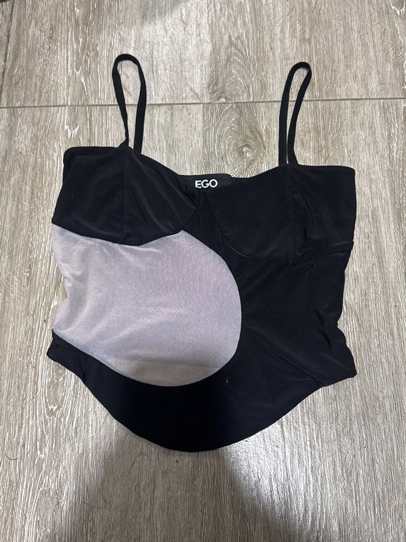 Black crop top with mesh panel and spaghetti straps (Category: Sleeveless) located in Pateros City. Submitted by sophiahipolito (Listing ID 1469516932, Image 1). Description: - Brand: EGO - Size: Medium (stretchy, snug fit) - Color: Black - Design: Asymmetric sheer mesh panel on the front with a straight neckline - Straps: Adjustable spaghetti straps - Hemline: Pointed front hem and curved back hem - Condition: Great shape, worn only a couple of 