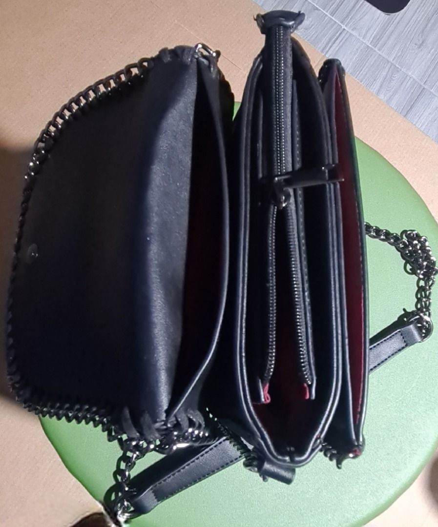 Black Crossbody Bag With Chain Strap And Multi Compartments (Category: Cross-body Bags) located in Marikina City. Submitted by reloved.closet26 (Listing ID 1469533726, Image 2). Description: Black crossbody bag, structured flap top design. Thick chain trim along the edges. Dark gunmetal chain strap with a leather shoulder rest piece. Multiple interior sections inside, plus a zipped middle pouch to keep things organized. Deep pink lining inside. M