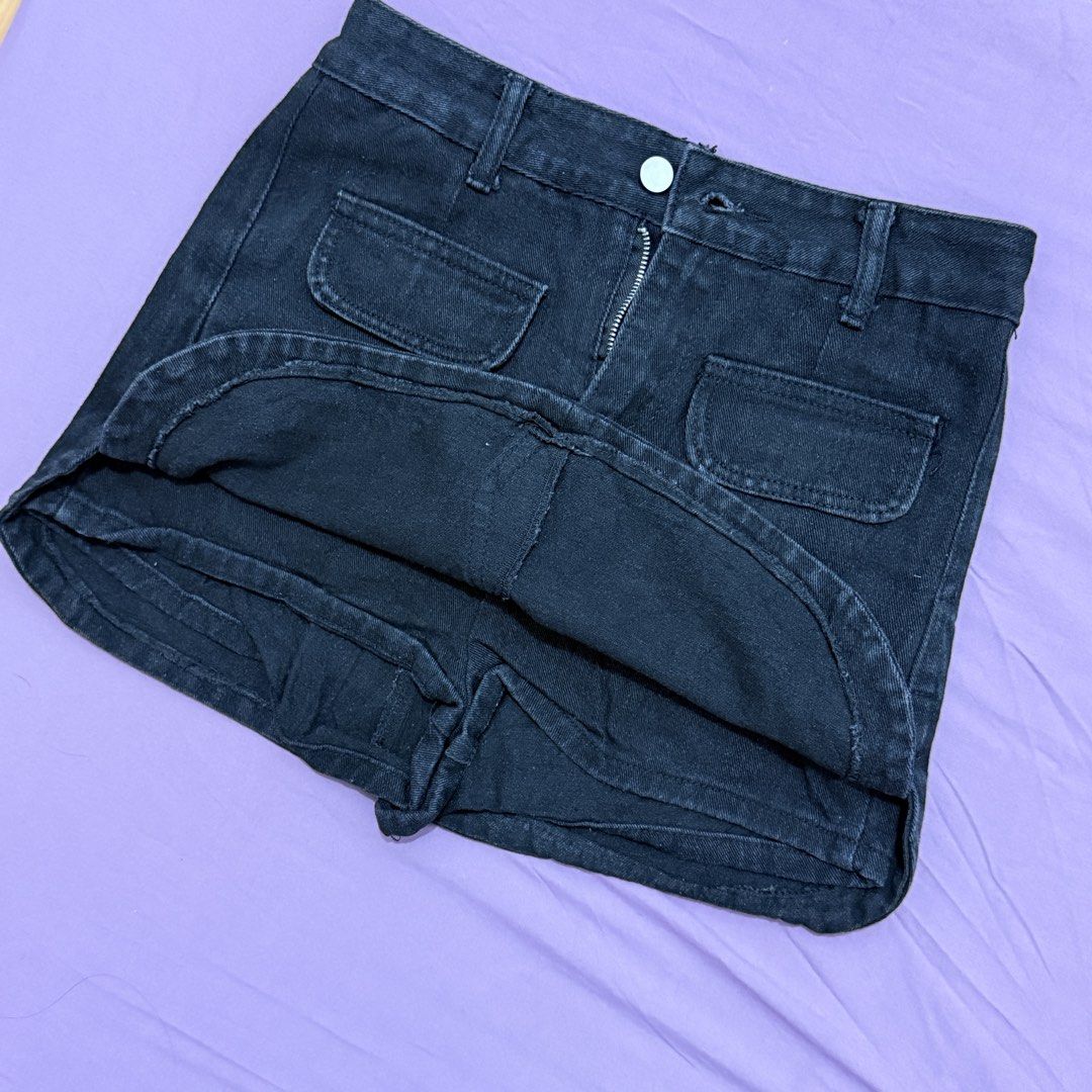 Black Denim Skort Front Pocket Built-in Shorts (Category: Skirts) located in Legazpi City. Submitted by maerixx (Listing ID 1469507974, Image 2). Description: Size 27-28 - Color/Wash: Dark wash black denim - Fit: Slight stretch with curved side hemline - Safety: Built-in shorts underneath for zero accidents - Pockets: Two front patch pockets and two back pockets - Closure: Front zip fly with silver button and belt loops.