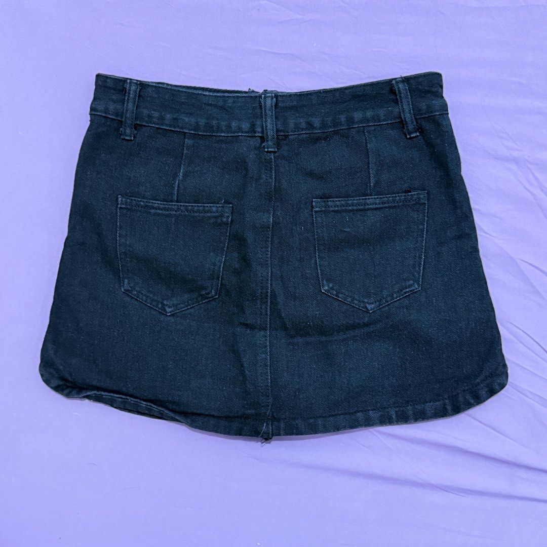 Black Denim Skort Front Pocket Built-in Shorts (Category: Skirts) located in Legazpi City. Submitted by maerixx (Listing ID 1469507974, Image 3). Description: Size 27-28 - Color/Wash: Dark wash black denim - Fit: Slight stretch with curved side hemline - Safety: Built-in shorts underneath for zero accidents - Pockets: Two front patch pockets and two back pockets - Closure: Front zip fly with silver button and belt loops.