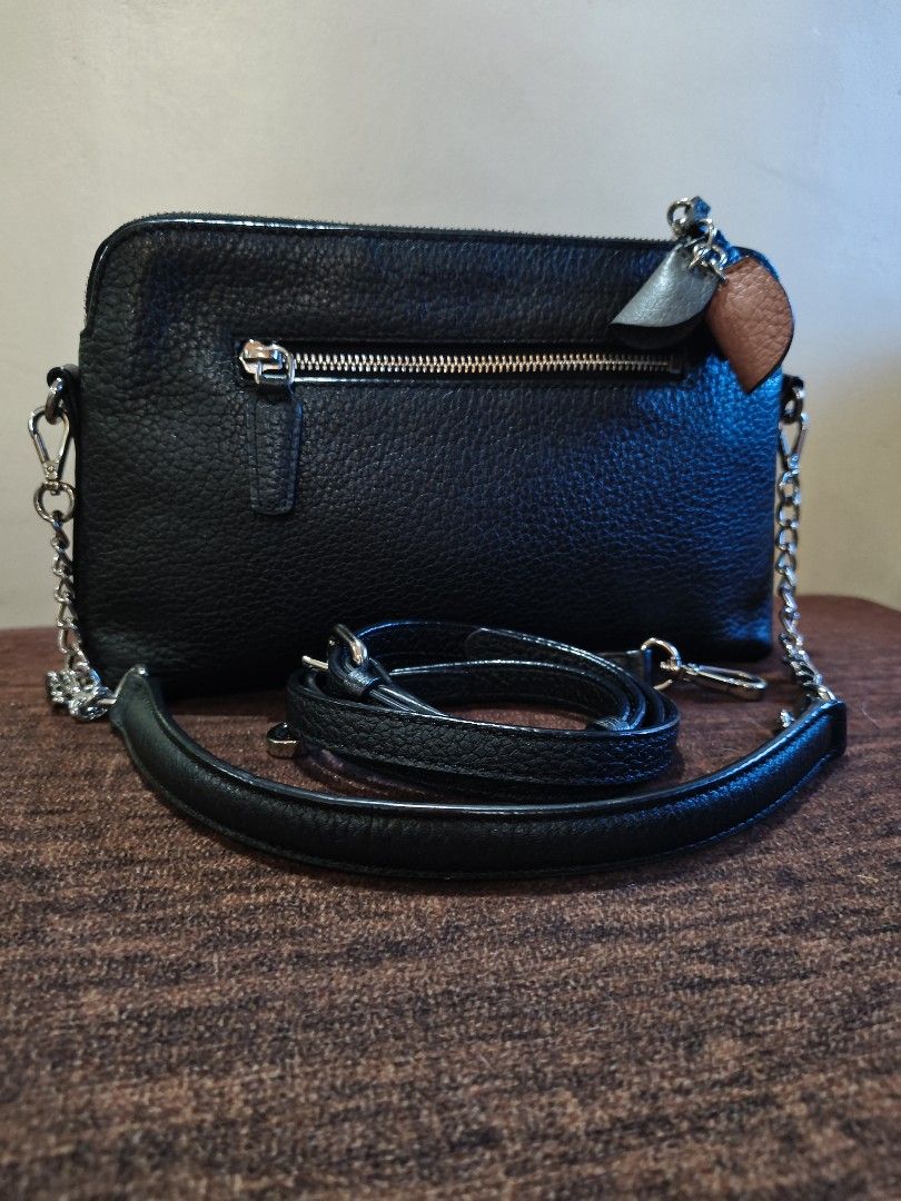 Anne Klein Black leather crossbody bag with chain strap (Category: Cross-body Bags) located in Bulacan. Submitted by marichuman79038 (Listing ID 1469413542, Image 3). Description: - Style: Crossbody bag - Material: Black pebbled leather with silver-tone hardware - Straps: Includes a detachable leather strap and a chain strap - Storage: Back zipper pocket for extra organization - Condition: Clean interior and exterior, ready to use - Extras: Cute 