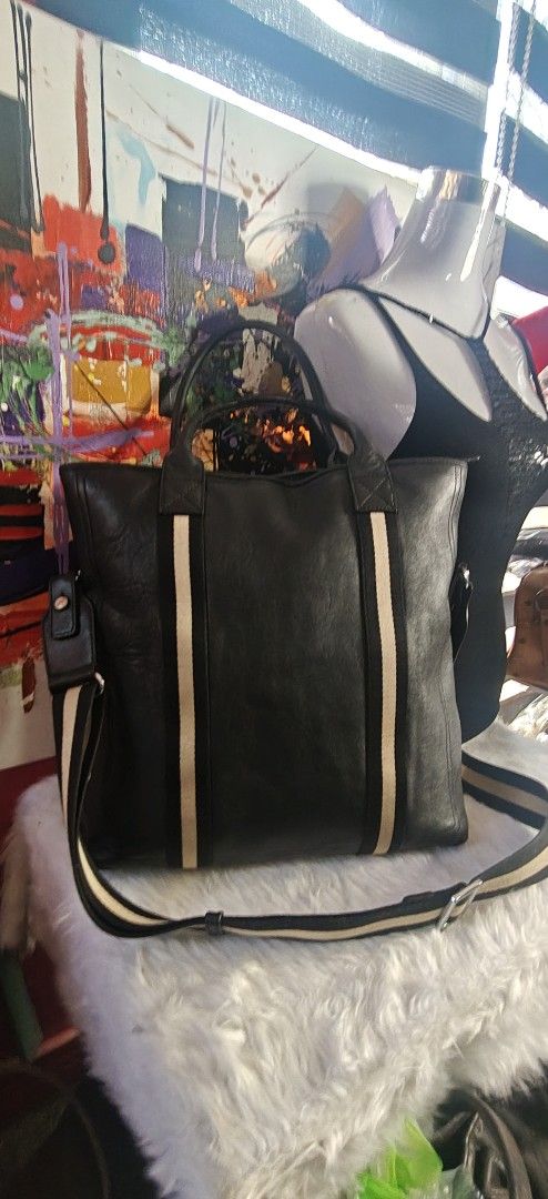 Black Leather Tote Bag with Striped Webbing Handles (Category: Tote Bags) located in Las Pinas. Submitted by liezel49 (Listing ID 1469423842, Image 2). Description: - Material: Premium black leather with silver-tone hardware - Design: Stylish vertical striped webbing on the front - Straps: Comfortable rolled top handles and a wide matching striped shoulder strap - Interior: Deep and spacious main compartment for all your essentials - Structure: S