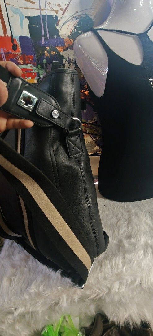 Black Leather Tote Bag with Striped Webbing Handles (Category: Tote Bags) located in Las Pinas. Submitted by liezel49 (Listing ID 1469423842, Image 3). Description: - Material: Premium black leather with silver-tone hardware - Design: Stylish vertical striped webbing on the front - Straps: Comfortable rolled top handles and a wide matching striped shoulder strap - Interior: Deep and spacious main compartment for all your essentials - Structure: S
