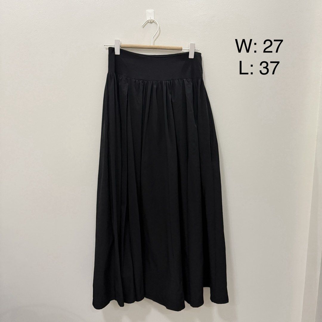 Black Long Maxi Skirt (Category: Skirts) located in Rodriguez. Submitted by jrms23 (Listing ID 1469542473, Image 1). Description: - Style: High-waisted pleated maxi skirt - Color: Classic black - Material: Lightweight and super flowy - Measurements: Waist 27" | Length 37" - Condition: Clean, well-stored in closet - Versatile piece, pairs easily with any basic top for casual wear.