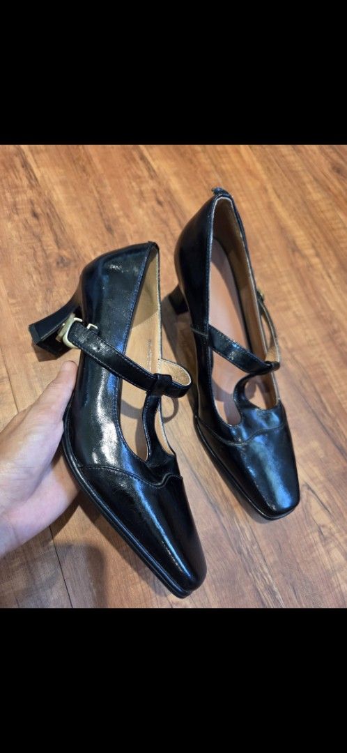 Black Mary Jane heels with ankle strap block heel (Category: Heels) located in Manila. Submitted by mysticrabbit.284012 (Listing ID 1469505016, Image 1). Description: - Style: Black Mary Jane heels with a modern pointed toe - Finish: Elegant glossy exterior with a neutral tan inner lining - Design: Unique curved strap across the foot and ankle with a secure small metal buckle - Heel: Stylish and stable flared block heel - Condition: Brand new, pe