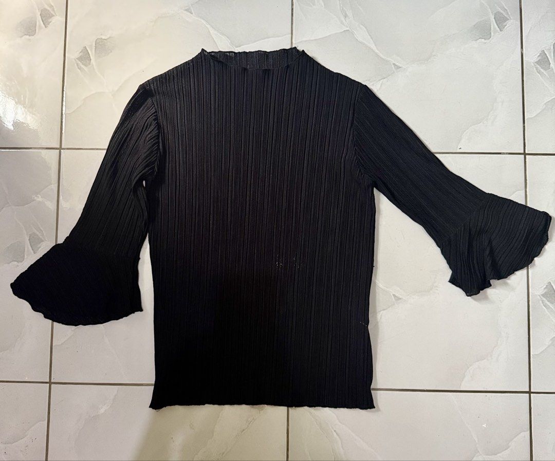 Black Pleated Long Sleeve Blouse with Flared Cuffs (Category: Longsleeves) located in Cagayan de Oro. Submitted by ninaaam (Listing ID 1469430263, Image 1). Description: - Color: Black - Design: All-over vertical pleats with mock neckline - Sleeves: Trendy flared bell cuffs - Material: Comfortable, stretchy fabric - Styling: Versatile staple piece, easy to match with skirts or pants for casual or dressy looks.