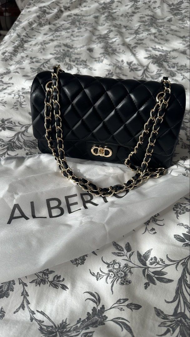 Black Quilted Handbag with Chain Strap (Category: Shoulder Bags) located in Quezon City. Submitted by mommyjoanne24 (Listing ID 1469396344, Image 1). Description: - Color: Classic black with striking bright pink inner lining - Design: quilted pattern - Strap: gold-tone chain interwoven with black material (can be worn shoulder or cross body) - Closure: Secure magnetic snap button under the flap - Condition: New - Inclusions: Comes with dust bag.