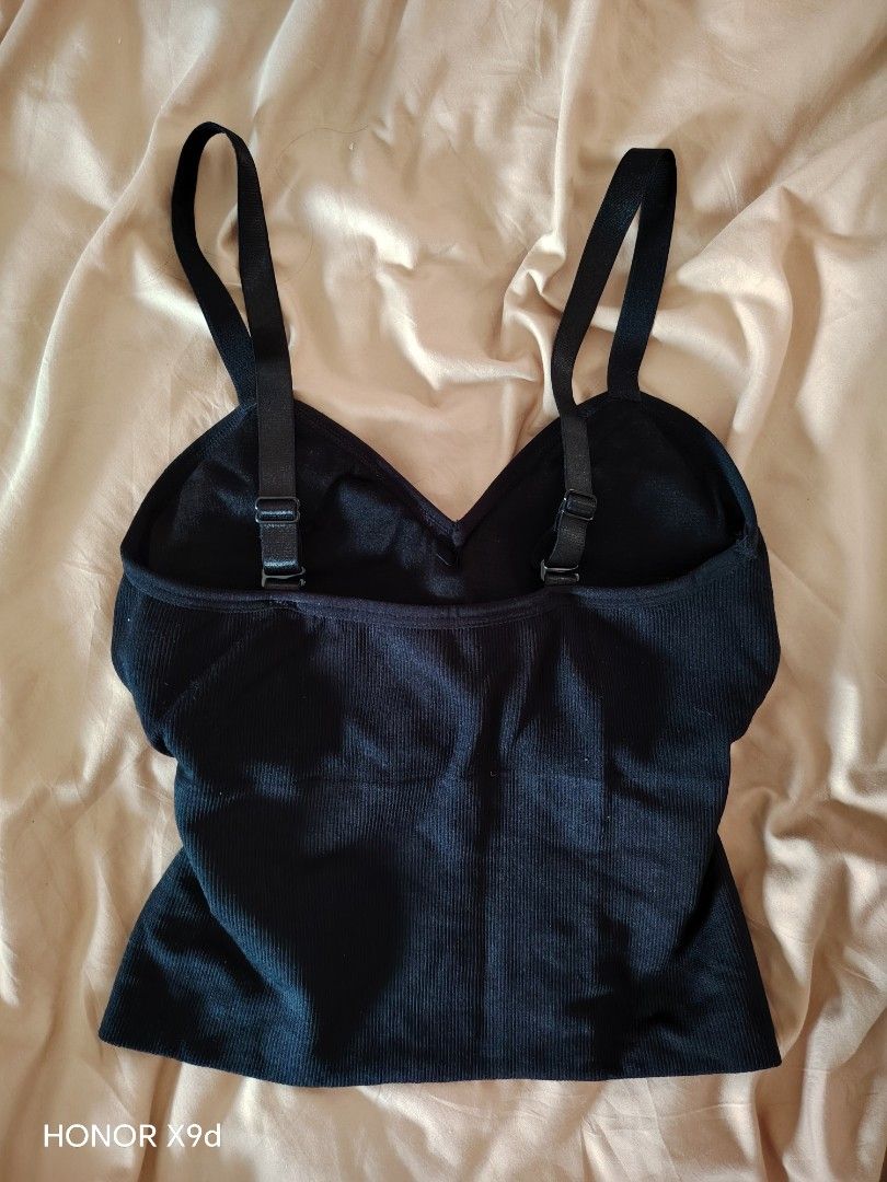 Black ribbed padded camisole crop top (Category: Sleeveless) located in Mabalacat. Submitted by Jackikay.PreLoved (Listing ID 1469512125, Image 2). Description: - Color: Black - Style: Cropped, fitted silhouette with V-neck - Comfort: Built-in padding for bra-free convenience - Straps: Adjustable double straps in the back - Material: Soft and stretchy ribbed fabric.