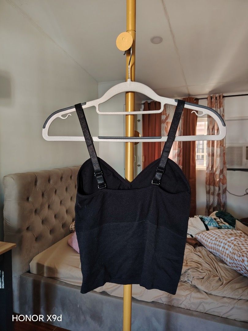 Black ribbed padded camisole crop top (Category: Sleeveless) located in Mabalacat. Submitted by Jackikay.PreLoved (Listing ID 1469512125, Image 3). Description: - Color: Black - Style: Cropped, fitted silhouette with V-neck - Comfort: Built-in padding for bra-free convenience - Straps: Adjustable double straps in the back - Material: Soft and stretchy ribbed fabric.