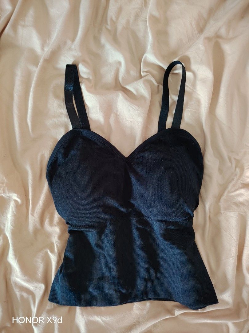 Black ribbed padded camisole crop top (Category: Sleeveless) located in Mabalacat. Submitted by Jackikay.PreLoved (Listing ID 1469512125, Image 1). Description: - Color: Black - Style: Cropped, fitted silhouette with V-neck - Comfort: Built-in padding for bra-free convenience - Straps: Adjustable double straps in the back - Material: Soft and stretchy ribbed fabric.