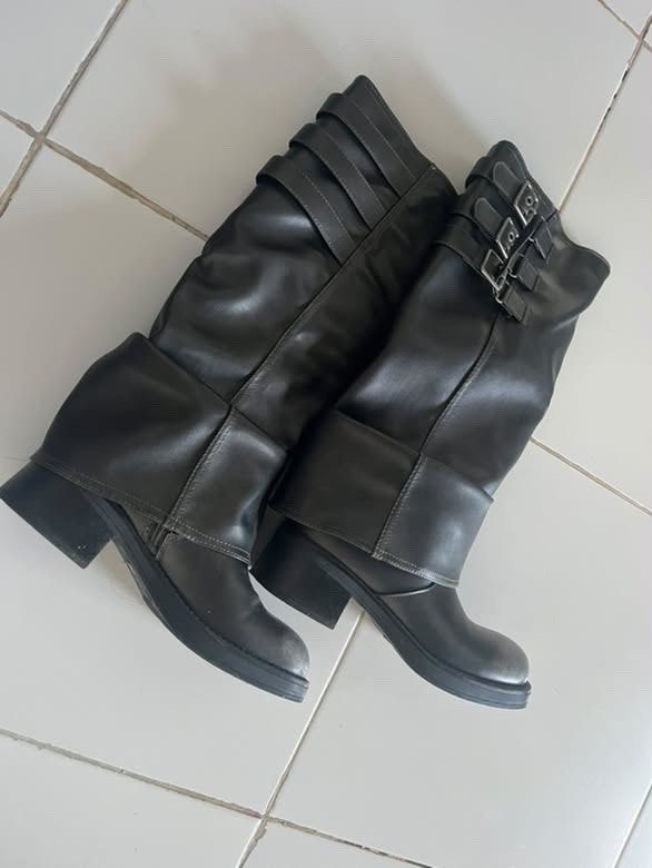 Black slouchy buckle knee high boots (Category: Boots) located in Manila. Submitted by lialrln (Listing ID 1469524798, Image 1). Description: - Color: Dark grey - Style: Knee-high boots with a slouchy folded shaft and grunge vibe - Details: Three buckle straps on the side upper collar, round toes, and textured faux leather material - Heel: Chunky low heel for all-day comfort - Pairing: Great to style with skirts or skinny jeans -only used once!.