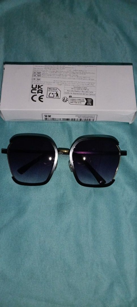 Black Square Sunglasses with Gradient Lenses and Box (Category: Sunglasses & Eyewear) located in Taguig. Submitted by trade_fairly (Listing ID 1469422524, Image 1). Description: - Style: Black square sunglasses with slim metal arms - Lenses: Trendy gradient lenses for everyday wear - Details: Elegant gold accent piece on the bridge - Condition/Inclusions: Brand new feel, includes original white packaging box with barcode and regulatory markings -