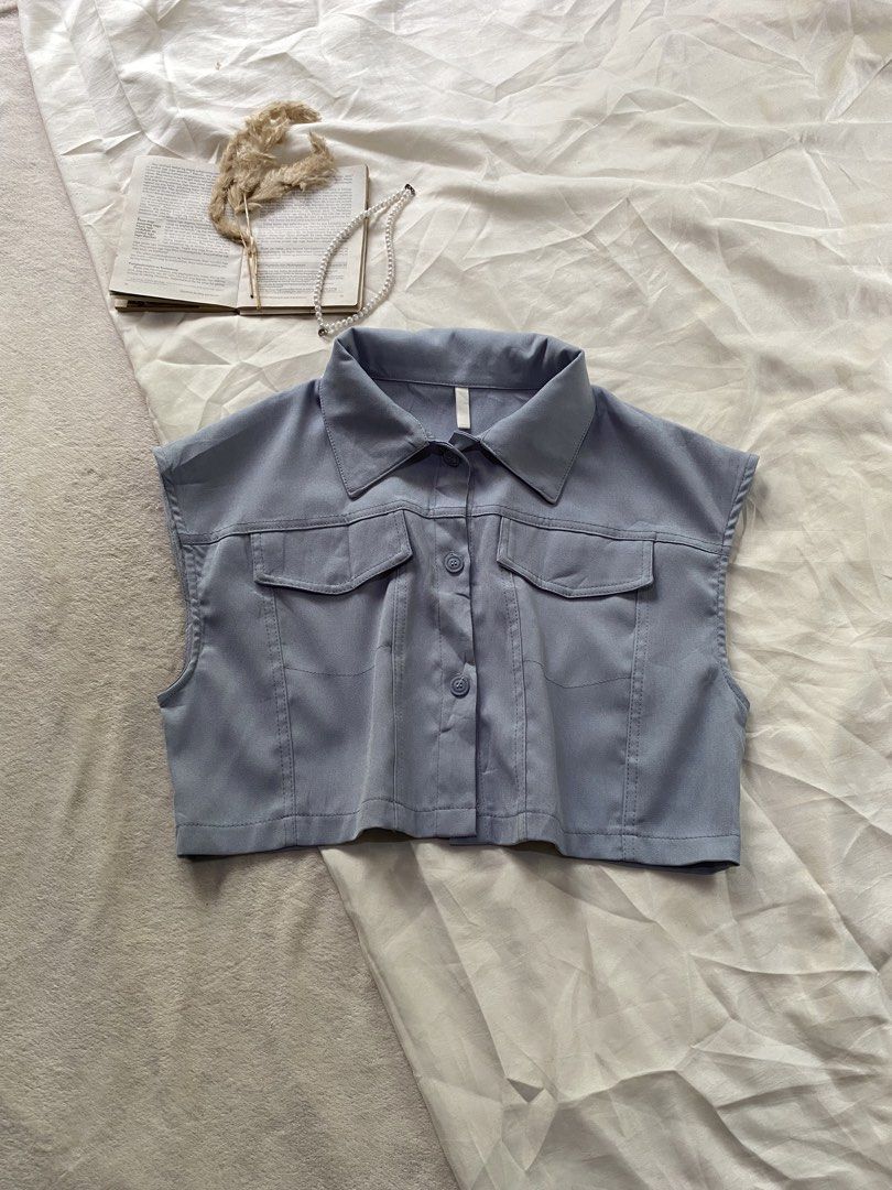 Blue Sleeveless Button-Up Crop Top with Pockets Large 41 (Category: Sleeveless) located in Poro. Submitted by joyceyuu (Listing ID 1469405667, Image 1). Description: - Style: Casual streetwear sleeveless crop top - Color: Light blue - Design: Classic collar, front button closure, and back yoke detail - Pockets: Two functional chest flap pockets - Quality: Structured fit with clean stitching all around - Styling: Pairs effortlessly with high-waist