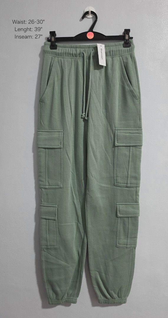 Bluenotes Green Cargo Sweatpants Size XS (Category: Jeans) located in Paranaque City. Submitted by franinnashop (Listing ID 1469459950, Image 1). Description: Declutter - Brand: Bluenotes - Color: Sage Green - Condition: Brand new with original store tag attached - Size: XS (Tag) - Waist: 26 to 30 inches (Elastic with drawstring) - Length: 39 inches - Inseam: 27 inches - Features: Side pockets, utility cargo pockets on both legs, and cuffed ankle
