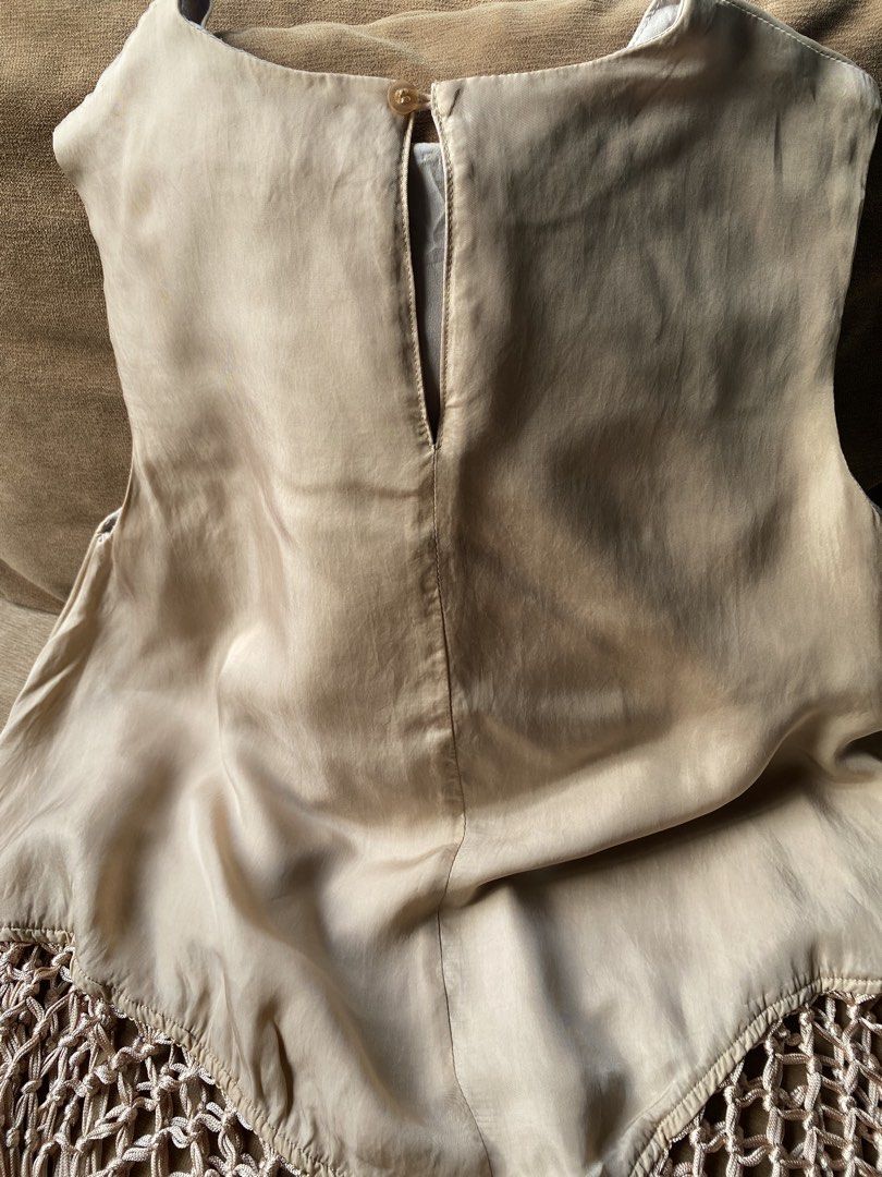 Boho Chic Fringed Top (Category: Sleeveless) located in Cebu City. Submitted by janb85 (Listing ID 1469465262, Image 2). Description: This is a champagne-colored sleeveless satin fabric featuring a high neckline, a handkerchief or asymmetric hem, and a decorative macramé crochet netting trimmed with hanging tassels. Keep it fun and clean and classy at the same time. Free size on tag but would recommend small to medium frames and not very busty. F
