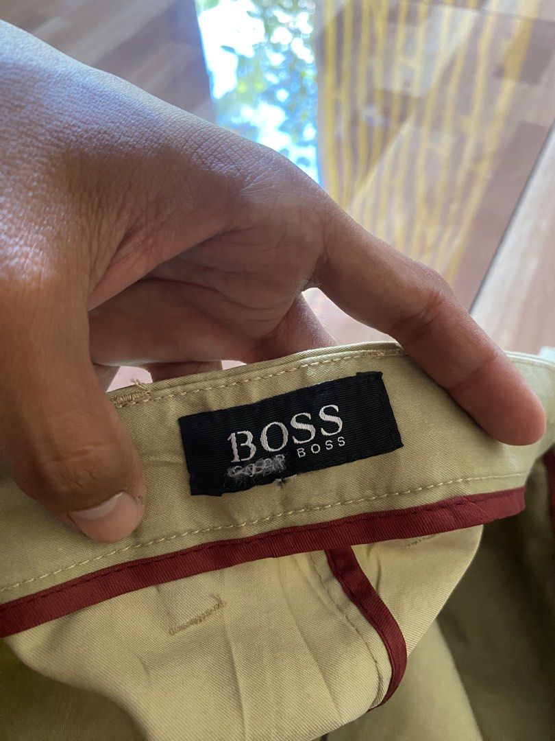BOSS Orange Classic Khaki Chino Pants (Category: Chinos) located in Pandi. Submitted by nasya_thrift_collection2023 (Listing ID 1469415219, Image 2). Description: - Brand: BOSS - Style: Classic khaki chino pants - Color: Versatile beige - Material: Comfortable cotton blend - Details: Back buttoned welt pocket with subtle logo tag, contrast red piping on interior waistband - Closure: Smooth YKK zip fly with button - Condition: Excellent pre-loved/