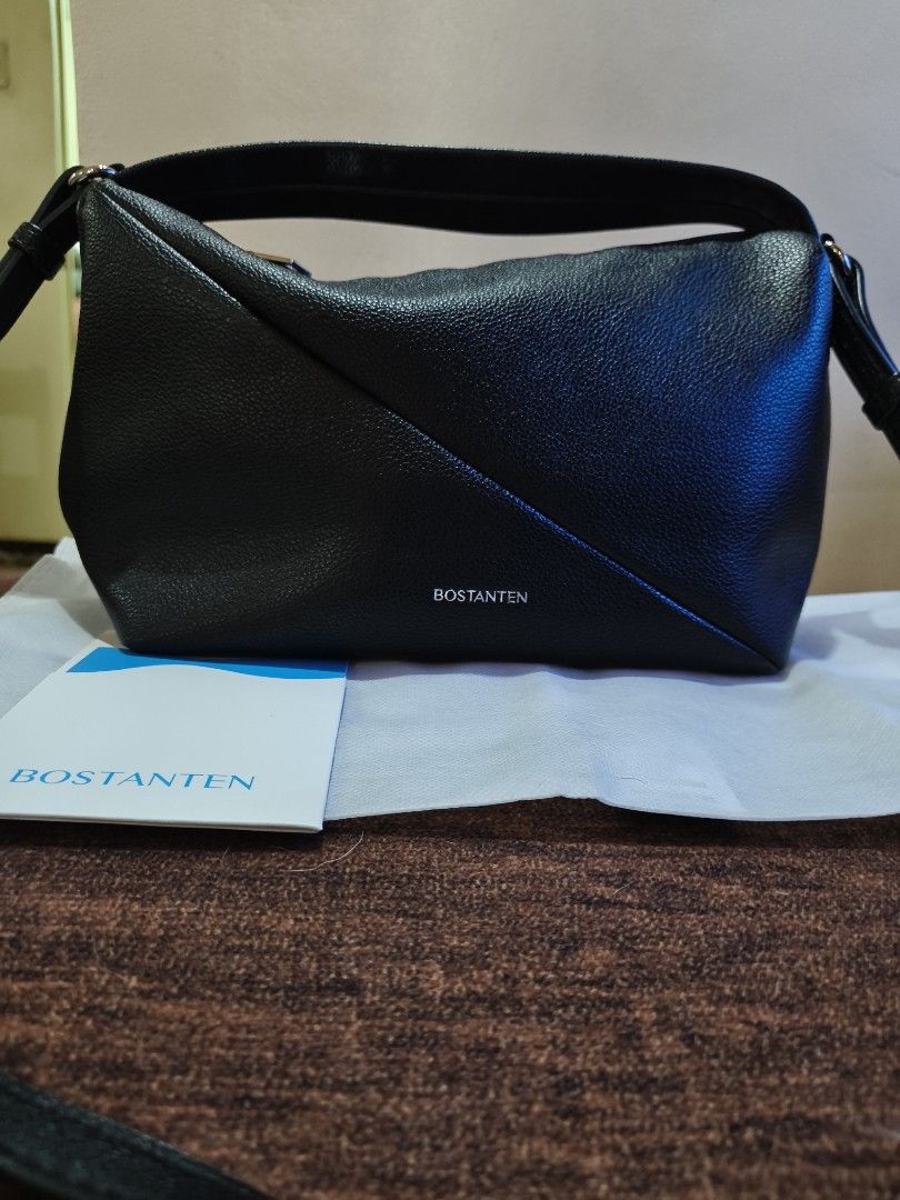 Bostanten Black Shoulder Bag (Category: Shoulder Bags) located in Bulacan. Submitted by marichuman79038 (Listing ID 1469434638, Image 2). Description: - Brand: Bostanten - Color: Classic Black - Material: Premium textured faux leather - Design: Stylish asymmetric front panel with silver branding lettering - Strap: Adjustable for custom comfort - Condition: Clean interior and exterior, ready to use - Inclusion: Comes with matching brand booklet/ca