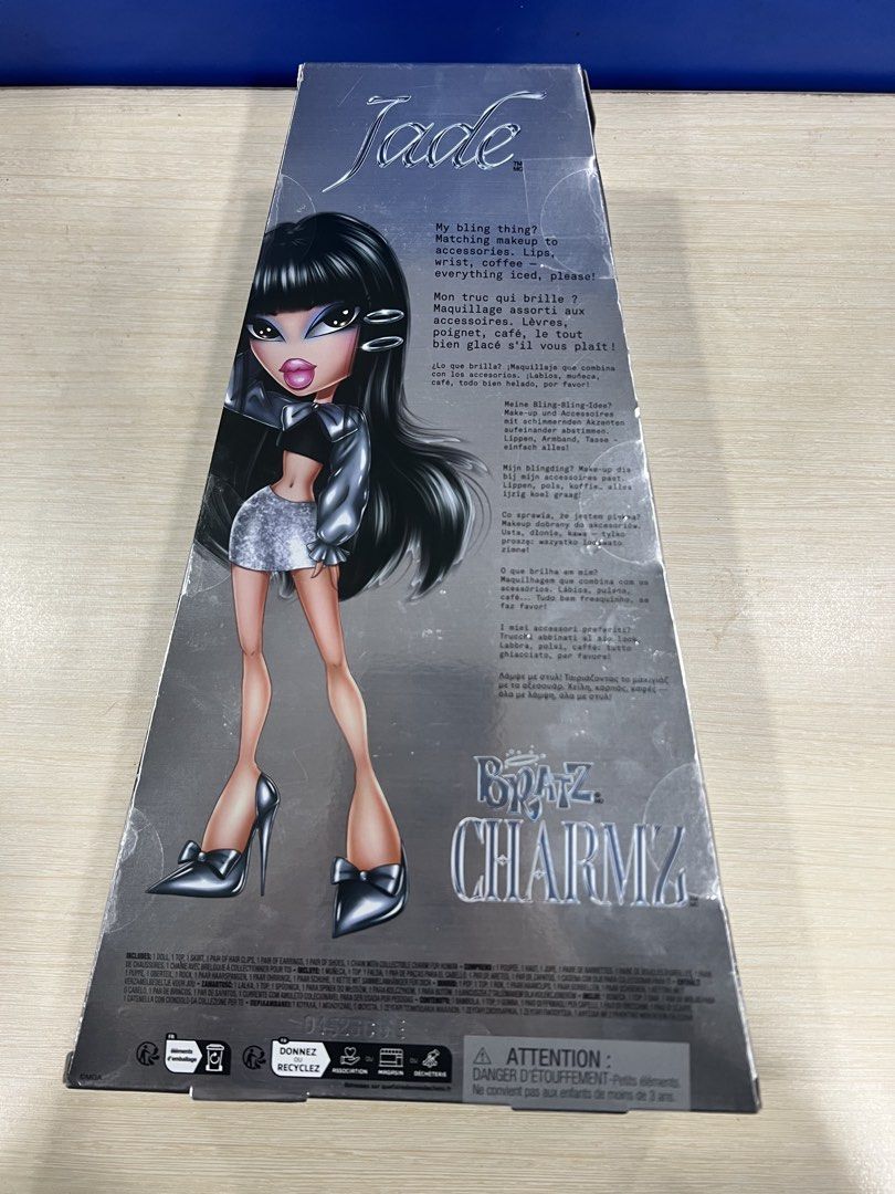 Bratz Charmz Jade Doll Unopened Box (Category: Kids Toys) located in Manila. Submitted by happydays.com (Listing ID 1469421143, Image 3). Description: - Brand: Bratz (Charmz Series - Jade) - Condition: Brand new, never removed from box (NRFB), crisp corners - Hair: Long black hair with signature bangs - Outfit: Metallic silver top, sparkly skirt, and matching heels - Accessories: Includes a chain necklace with a pink charm - Packaging: Clear fron