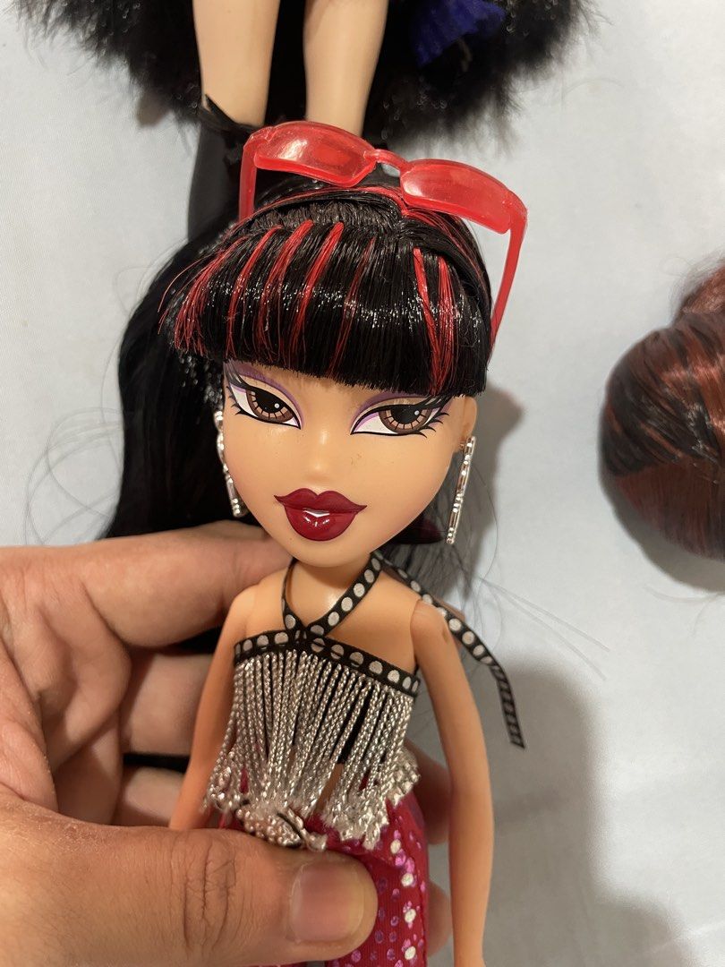 Bratz Tiana (Category: Kids Toys) located in Imus. Submitted by pawwwy45 (Listing ID 1469398444, Image 2). Description: - Bratz Jade doll in great, clean condition - Iconic black hair with red highlights and blunt bangs - Outfit: Silver fringe halter top, patterned pink flare pants, and black strappy heels - Accessories: Red sunglasses on head and silver hoop earrings - Face paint: Pristine dark purple eyeshadow and bold red lips - Mode of Paymen