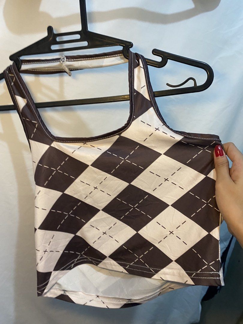 Brown and White Argyle Crop Top (Category: Shirts) located in Manila. Submitted by lily0528 (Listing ID 1469523770, Image 2). Description: Brown and white argyle pattern crop top. Square neckline with shoulder straps and a unique curved hemline. Smooth, lightweight material. Easy to style with high-waisted jeans or skirts. Worn a few times, still in great shape..