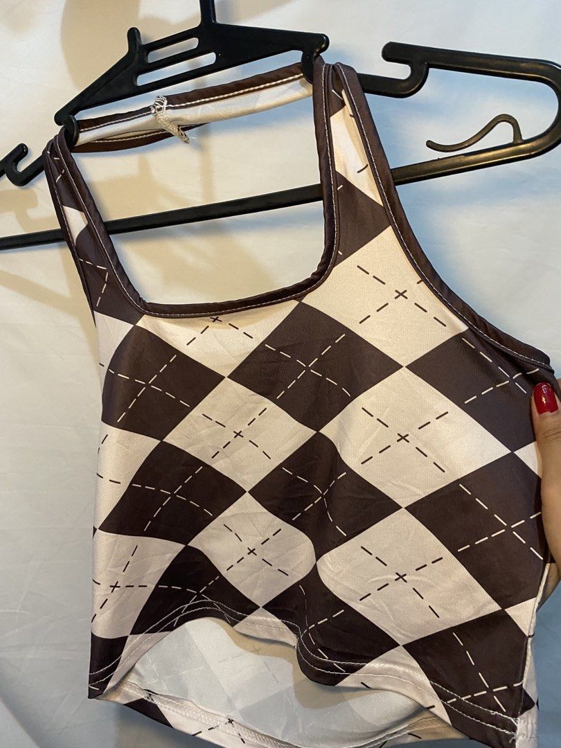 Brown and White Argyle Crop Top (Category: Shirts) located in Manila. Submitted by lily0528 (Listing ID 1469523770, Image 3). Description: Brown and white argyle pattern crop top. Square neckline with shoulder straps and a unique curved hemline. Smooth, lightweight material. Easy to style with high-waisted jeans or skirts. Worn a few times, still in great shape..