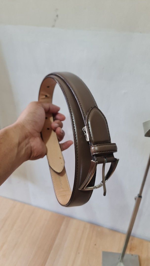 Brown Leather Belt with Silver Buckle (Category: Belts) located in Caloocan City. Submitted by royaldragon_d59aba (Listing ID 1469542596, Image 2). Description: - Material: YSL Genuine brown leather with clean beige interior lining - Hardware: Polished silver-tone metal buckle - Design: Classic edge stitching with multiple adjustment holes - Style: Simple and versatile everyday accessory.