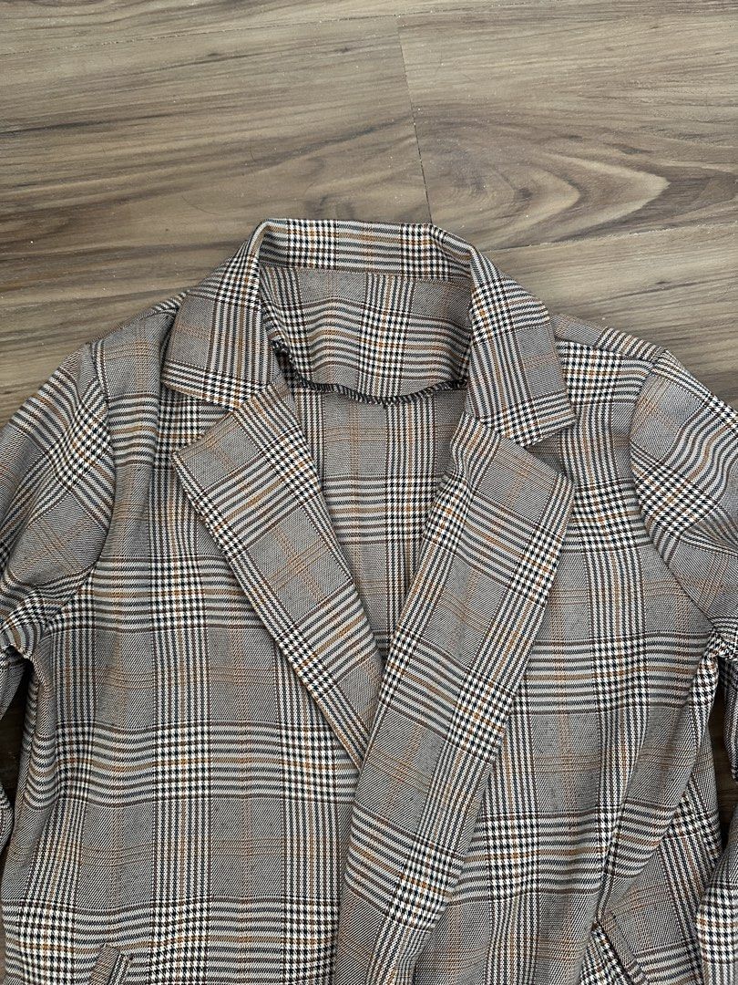 Brown Plaid Blazer Coat Jacket (Category: Coats, Jackets and Outerwear) located in Paranaque City. Submitted by declutterwyae (Listing ID 1469404103, Image 2). Description: - Brown and black plaid blazer - Single black button front closure - Classic lapel collar and long sleeves - Two functional front pockets - Lightweight, neutral-toned checkered fabric - Clean seams and neat stitching throughout.