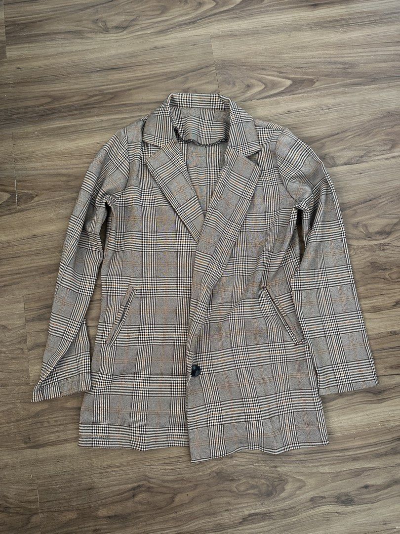 Brown Plaid Blazer Coat Jacket (Category: Coats, Jackets and Outerwear) located in Paranaque City. Submitted by declutterwyae (Listing ID 1469404103, Image 1). Description: - Brown and black plaid blazer - Single black button front closure - Classic lapel collar and long sleeves - Two functional front pockets - Lightweight, neutral-toned checkered fabric - Clean seams and neat stitching throughout.