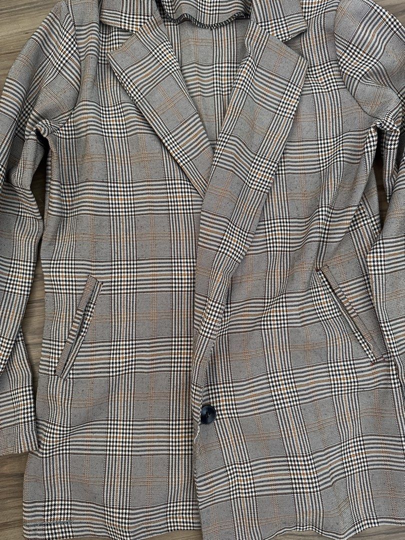 Brown Plaid Blazer Coat Jacket (Category: Coats, Jackets and Outerwear) located in Paranaque City. Submitted by declutterwyae (Listing ID 1469404103, Image 3). Description: - Brown and black plaid blazer - Single black button front closure - Classic lapel collar and long sleeves - Two functional front pockets - Lightweight, neutral-toned checkered fabric - Clean seams and neat stitching throughout.