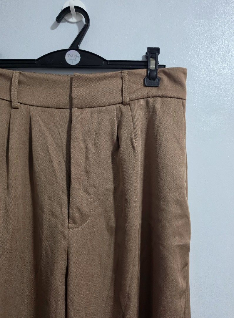 Brown Wide Leg Pleated Trousers (Category: Other Bottoms) located in Paranaque City. Submitted by franinnashop (Listing ID 1469452200, Image 2). Description: Declutter- Color: Brown - Style: Wide leg with pleated front detail - Features: Functional side pockets and belt loops - Closure: Secure front zipper and hook - Waist: 30-36 inches (adjustable/stretch) - Hips: 44 inches - Length: 38 inches - Inseam: 24 inches.
