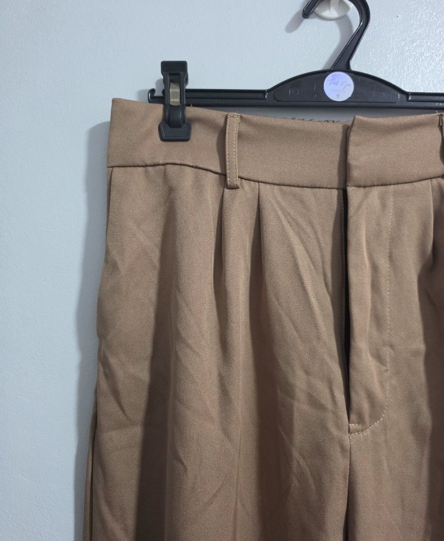 Brown Wide Leg Pleated Trousers (Category: Other Bottoms) located in Paranaque City. Submitted by franinnashop (Listing ID 1469452200, Image 3). Description: Declutter- Color: Brown - Style: Wide leg with pleated front detail - Features: Functional side pockets and belt loops - Closure: Secure front zipper and hook - Waist: 30-36 inches (adjustable/stretch) - Hips: 44 inches - Length: 38 inches - Inseam: 24 inches.