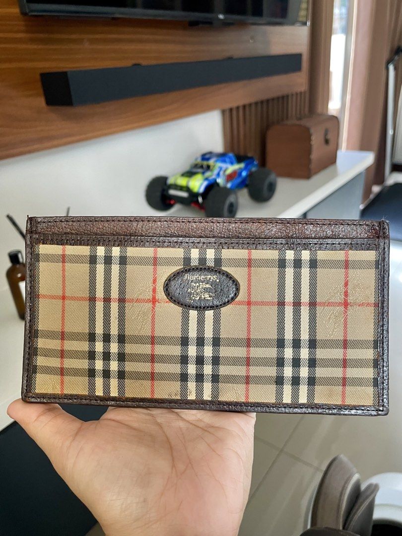 Burberrys Vintage Check Long Wallet (Category: Luxury Bags & Wallets) located in Paranaque City. Submitted by ol.authentic.ph (Listing ID 1469572302, Image 2). Description: - Authentic vintage Burberrys long wallet - Iconic nova check pattern with dark brown leather trim - Elegant oval logo plaque on the front - Slim profile with multiple compartments for cards and cash - Minor wear from normal use, great for everyday styling.