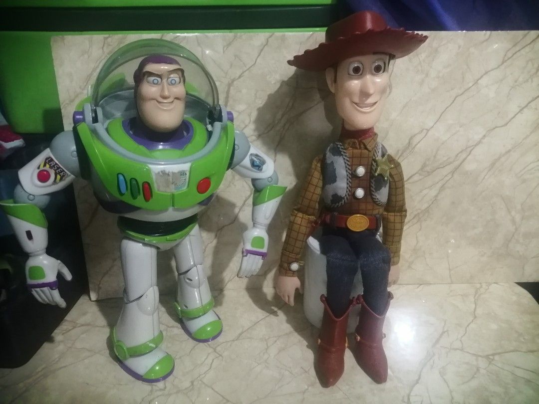 Buzz and Woody Thinkway Vintage (Category: Interactive Toys) located in Pateros City. Submitted by romferarc333 (Listing ID 1469435566, Image 2). Description: Vintage Buzz and Woody 1995/96 release Interactive toys from Thinkway Toys Buzz -working voice and lights -no wing effect (just a design hidden wings) -missing left thumb -paint chips Woody: -working voice box -no pull string (first release version) -push button on shirt -faded vest and clo